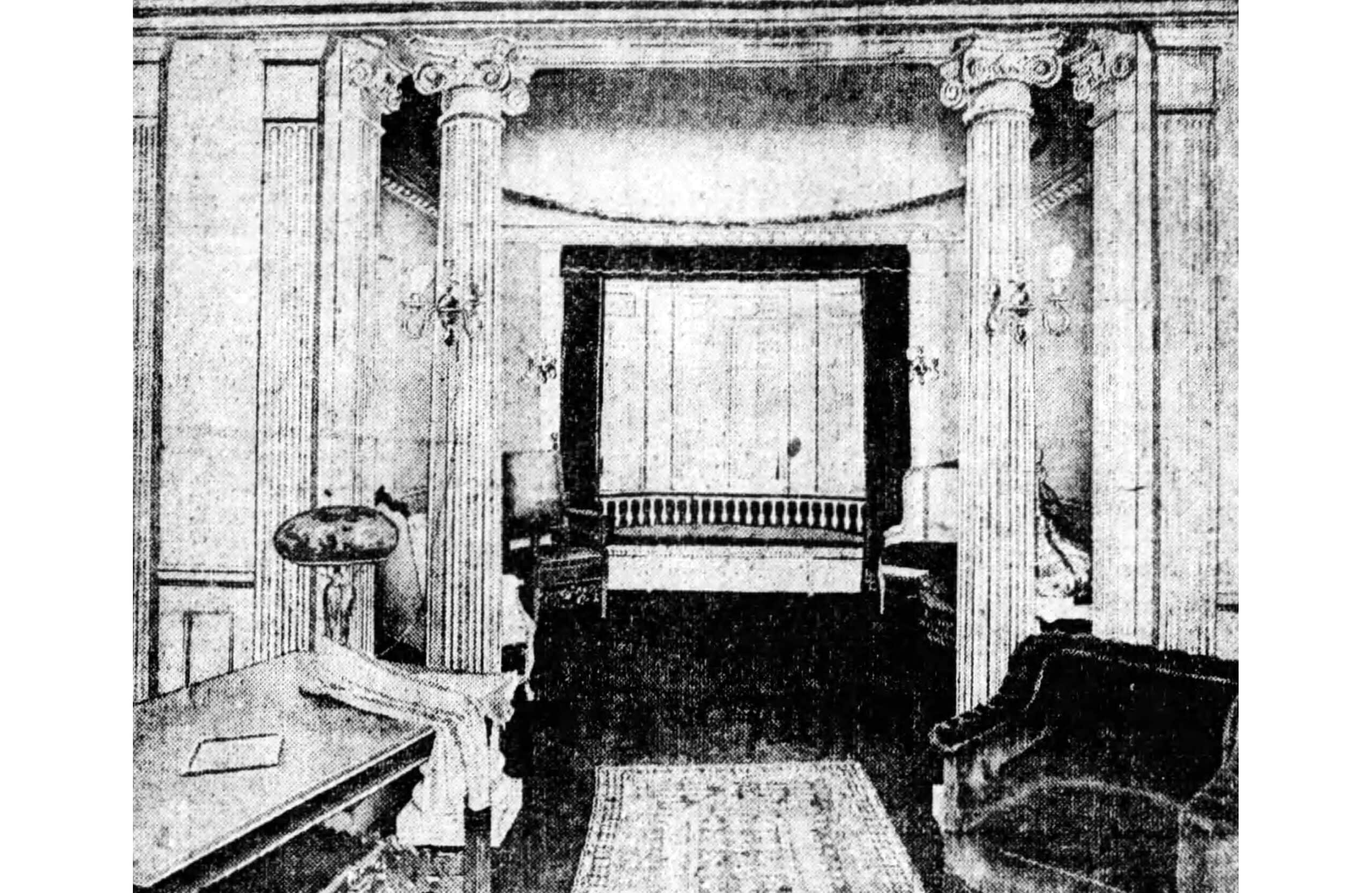 black and white image of a reception room with bench