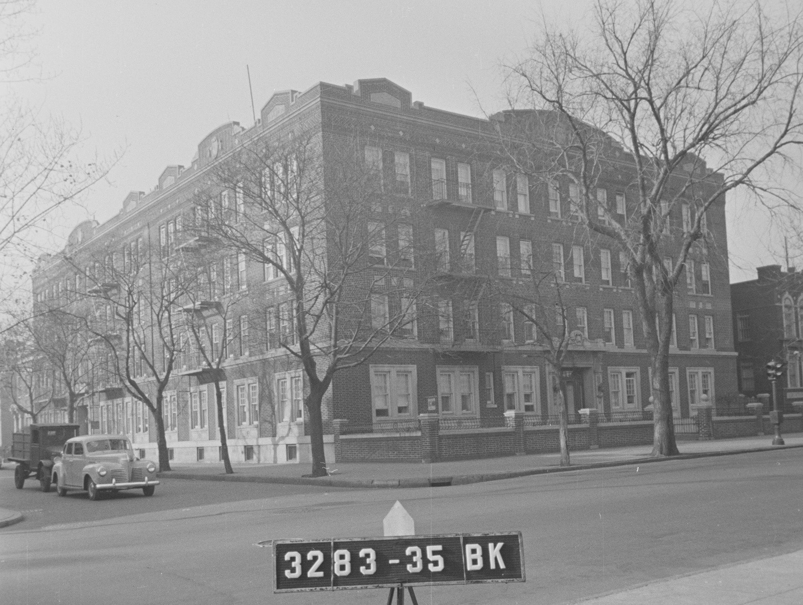 black and white photo of a brick apartment building