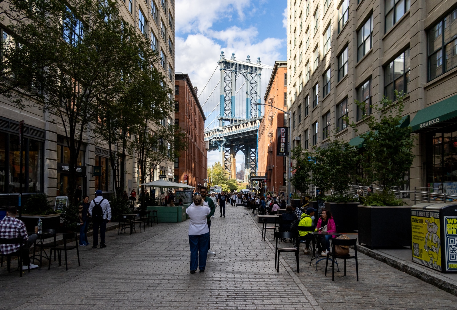 dumbo - tourists photographing the view of the manhattan bridge on washington street