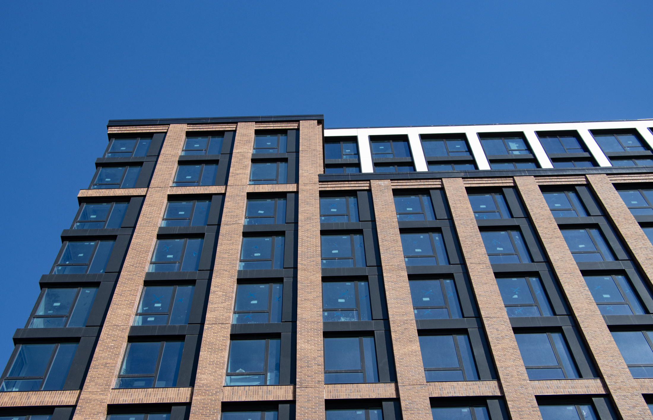 details of the brick building with dark windows