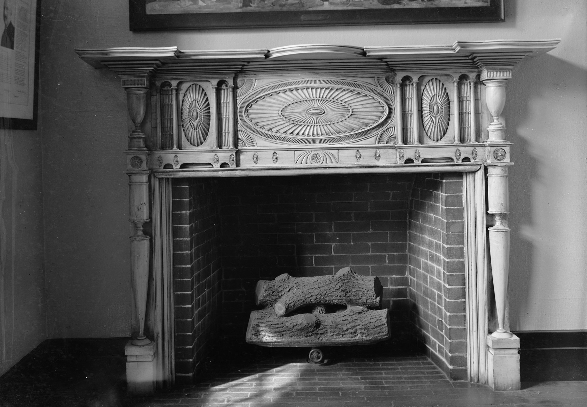 a black and white photo of a Federal style wood mantel