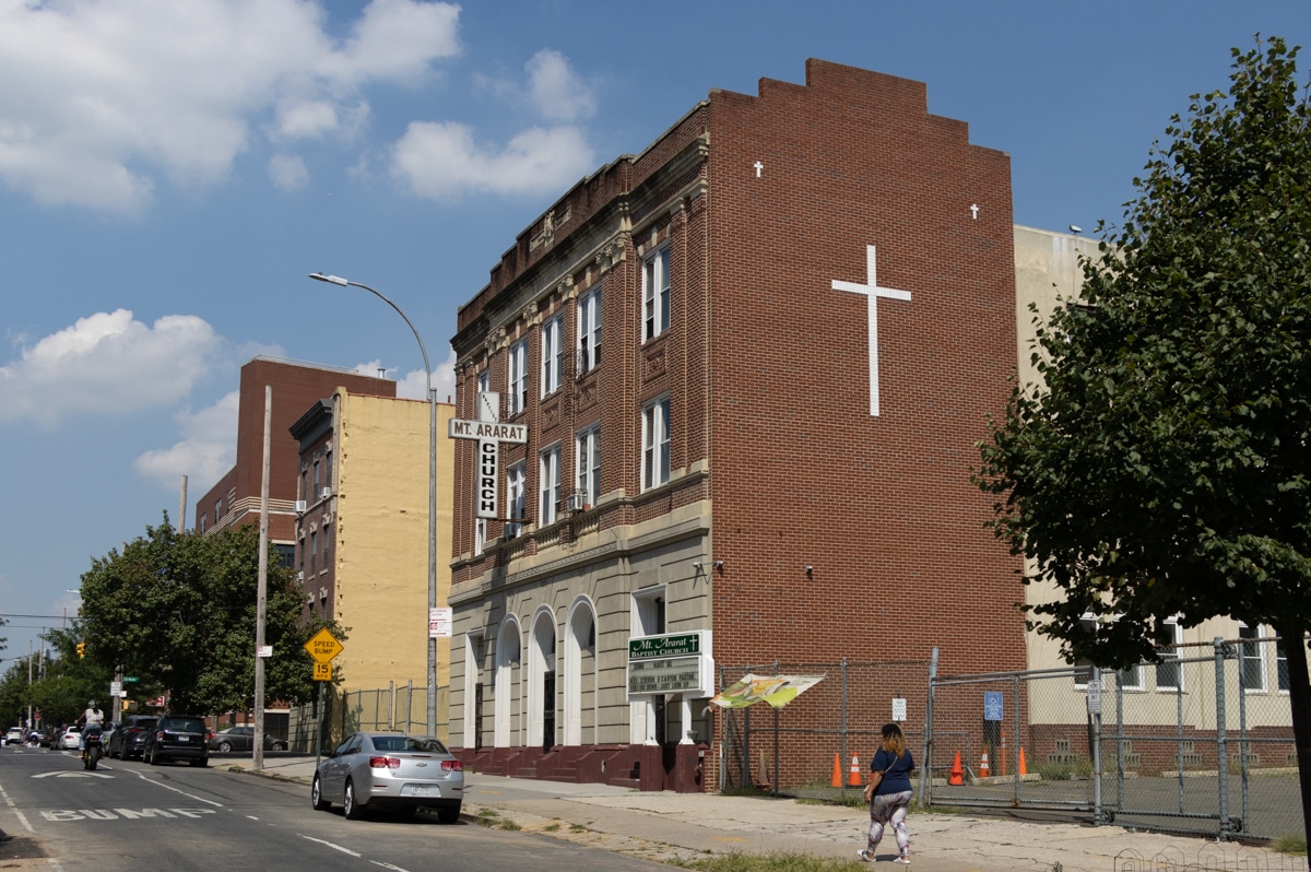 brick building with white cross on the side