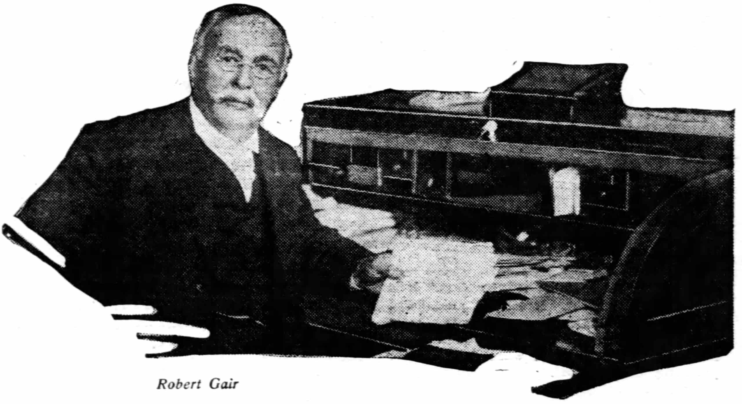 black and white portrait of robert gair at a desk