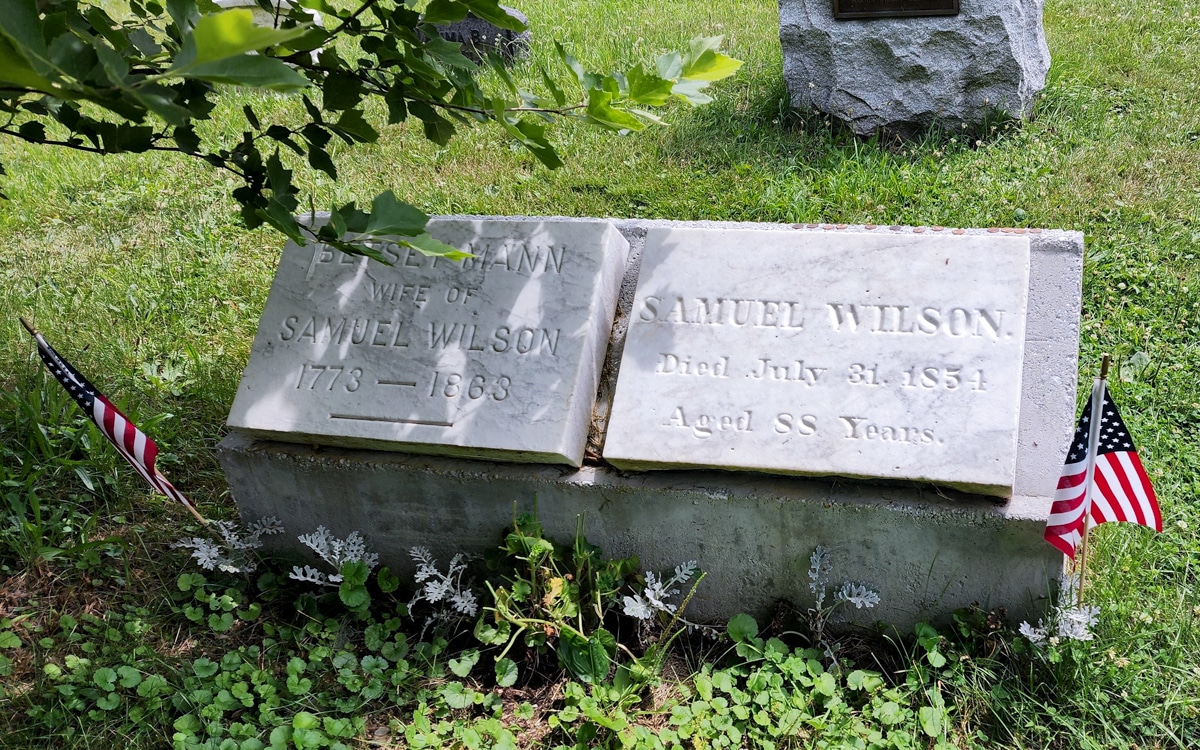 grave with small american flag next to it