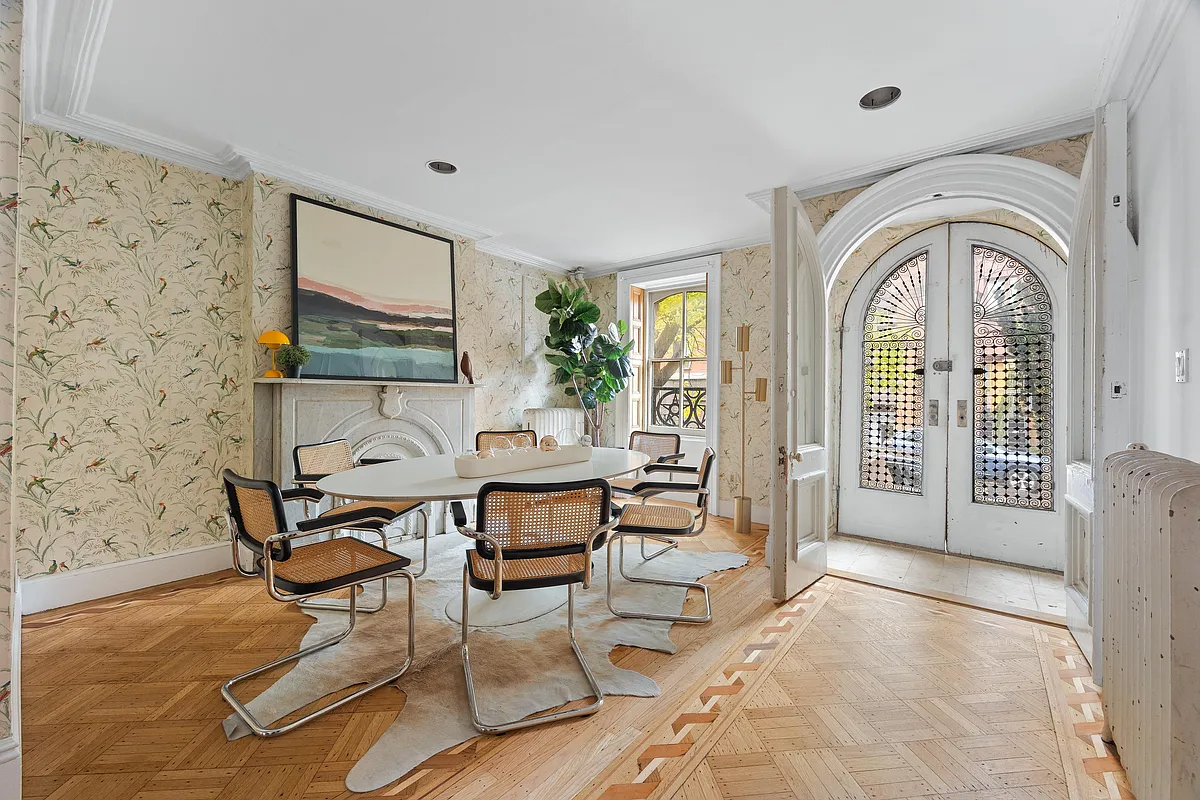 carroll gardens  dining room with marble mantel, wallpaper, door to garden