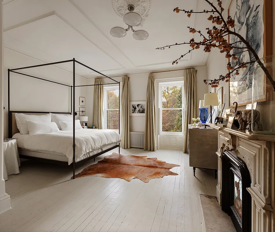 bedroom with a marble mantel, the floors and walls are all painted cream