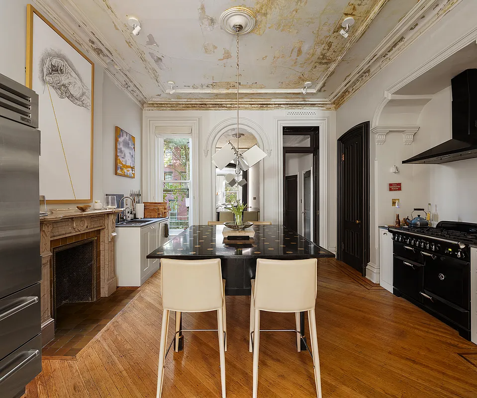 kitchen with marble mantel, center island, wood floor