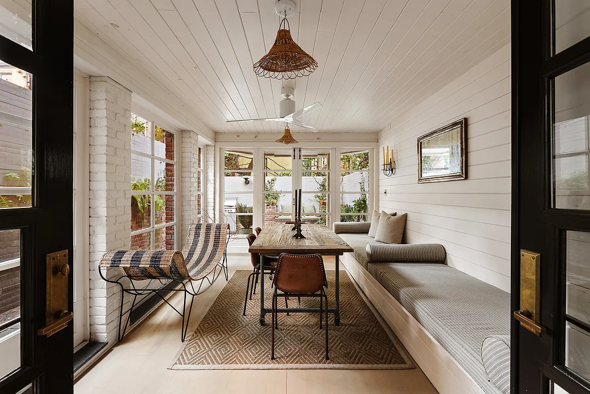 rear enclosed porch with room for dining