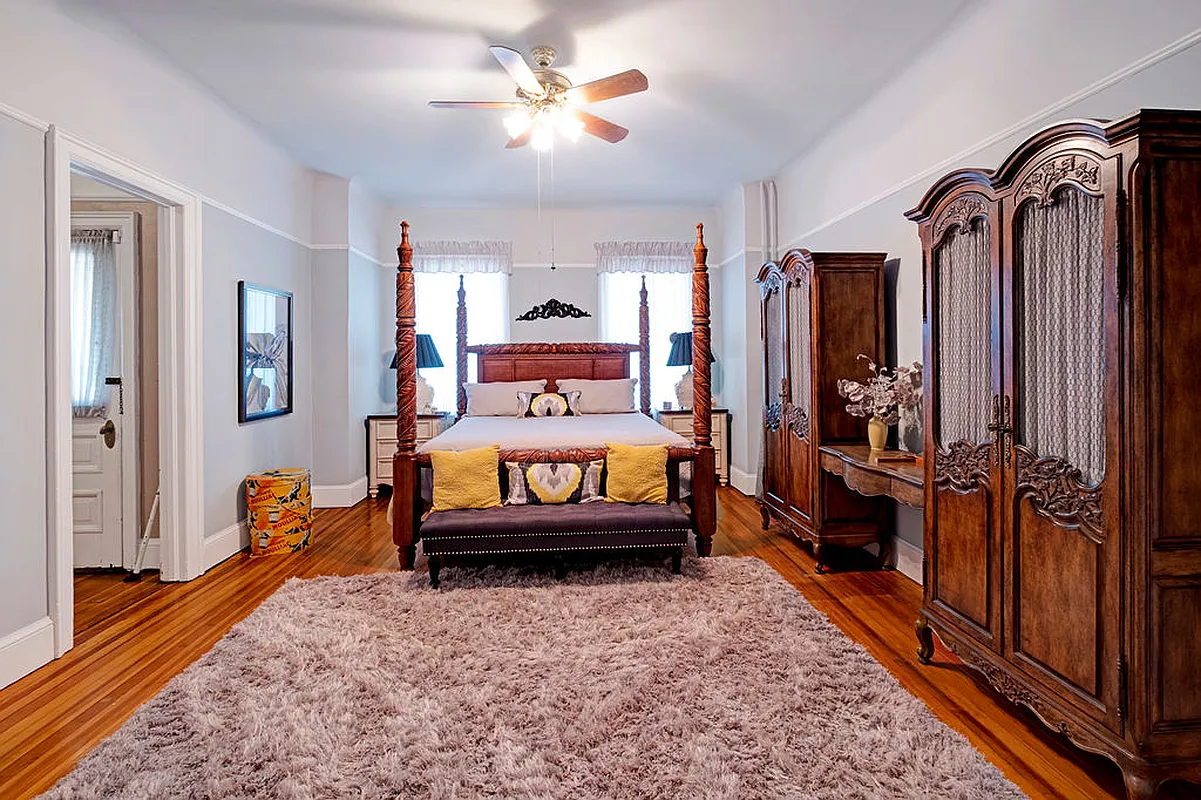 bedroom with wood floor, picture rail, ceiling fan