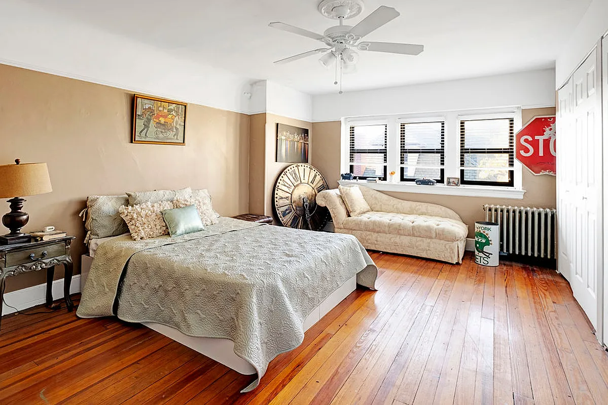 bedroom with wood floor, picture rail