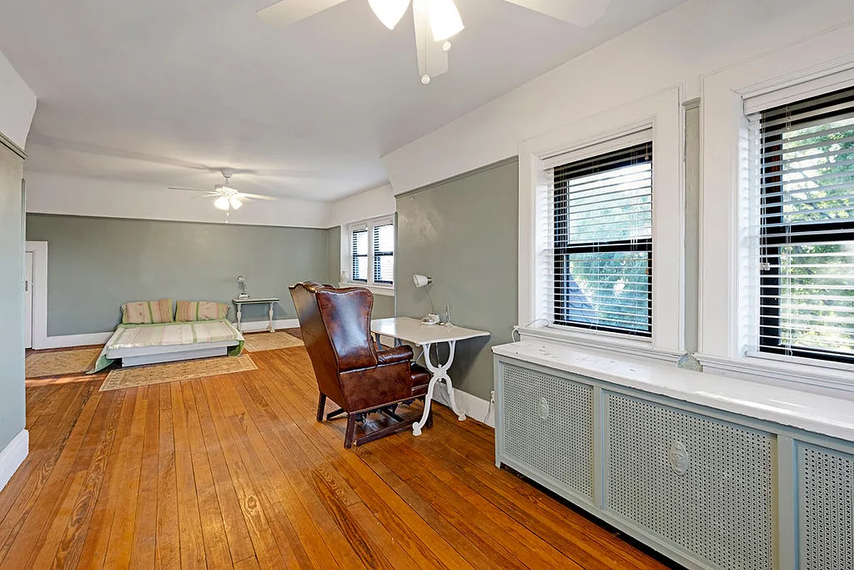 bedroom with picture rail and a wood floor