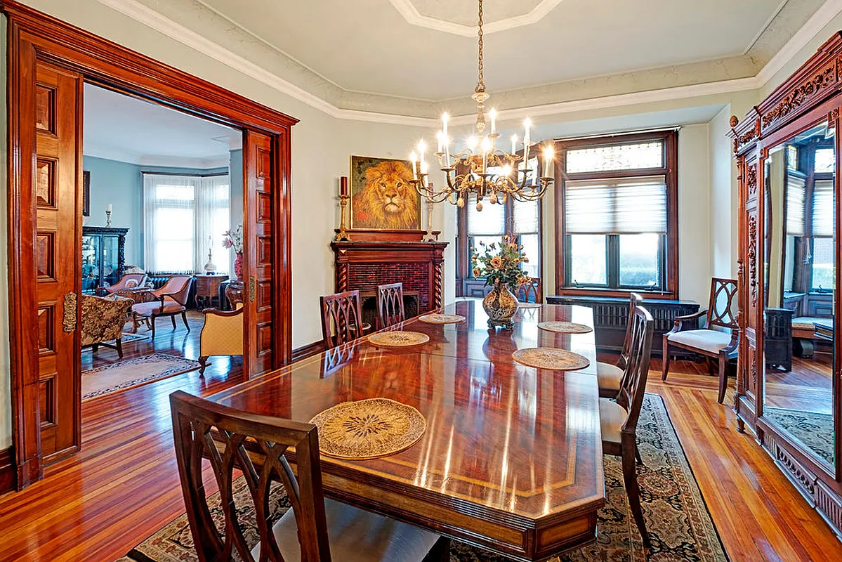 living room set up as a dining room with pocket doors, corner mantel