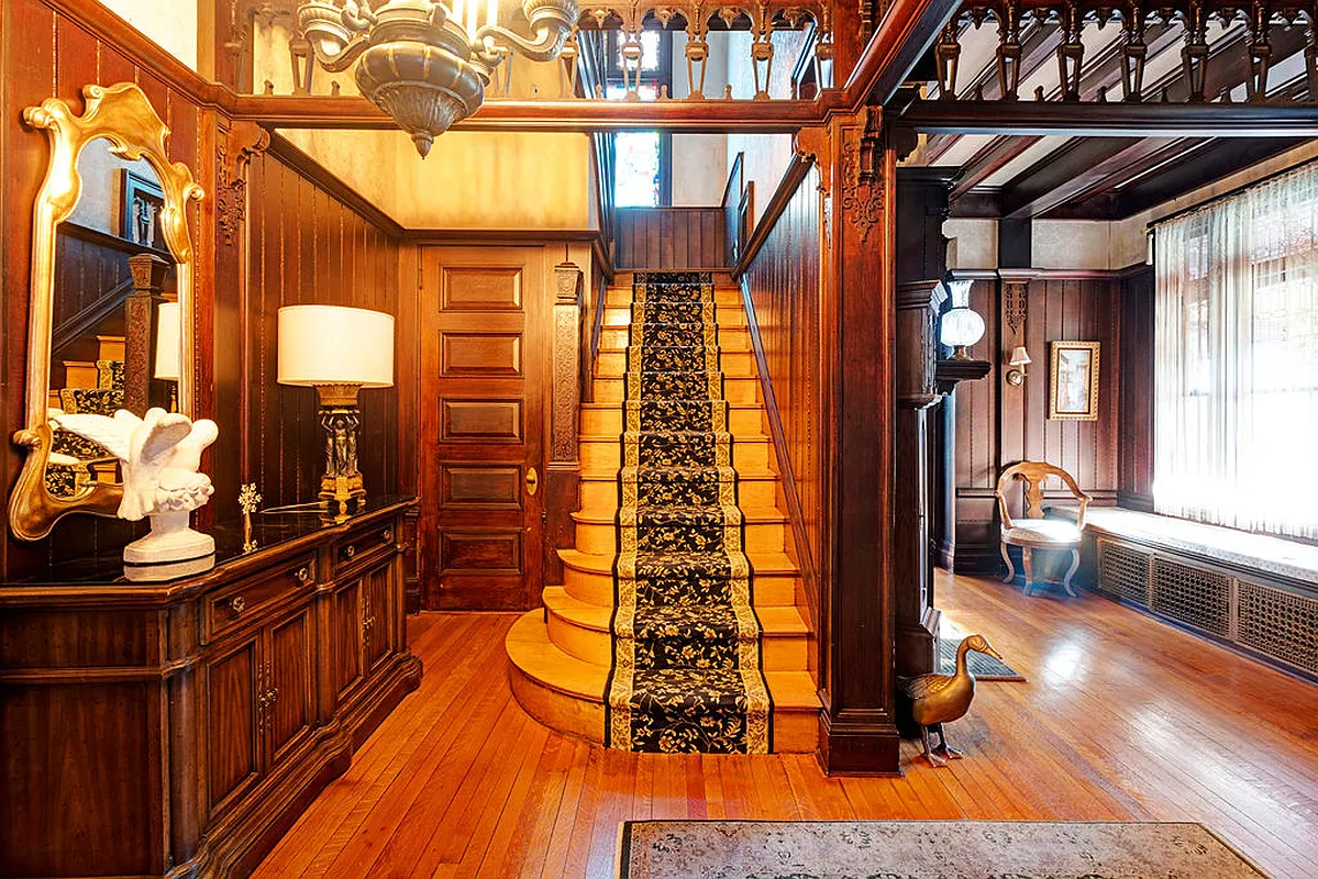 entry hall with stair, wainscoting, built-in bench