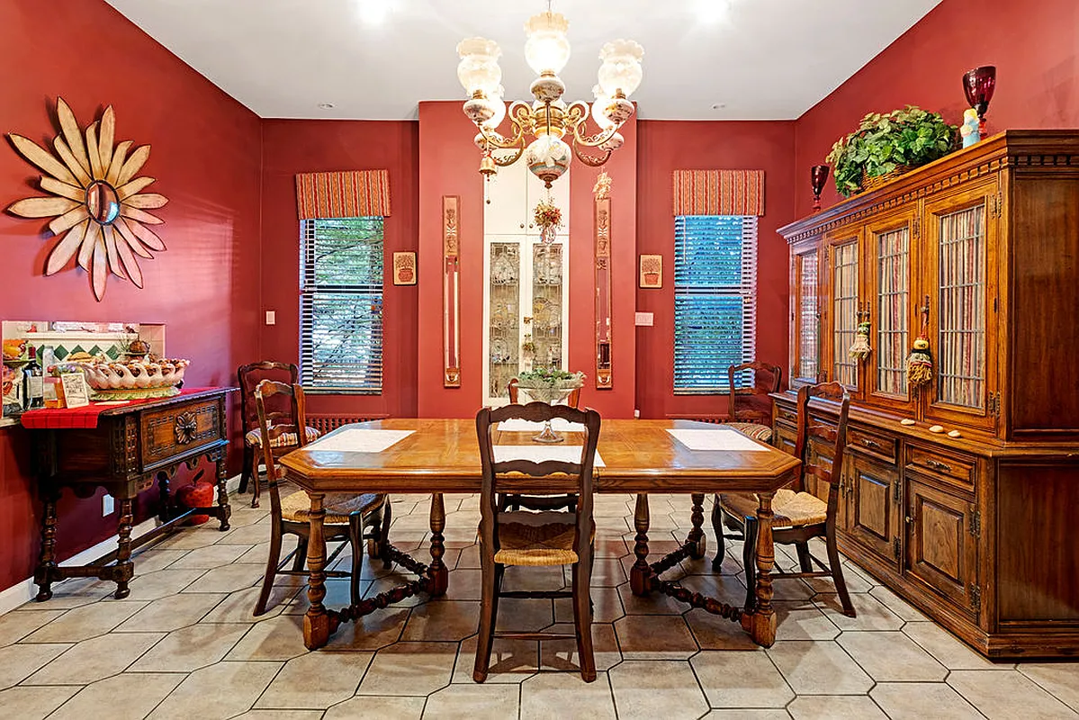 breakfast nook off kitchen with red walls and white ceramic tile floor