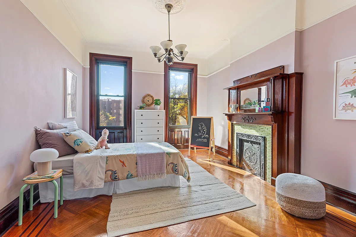 bedroom with wood mantel, pink walls