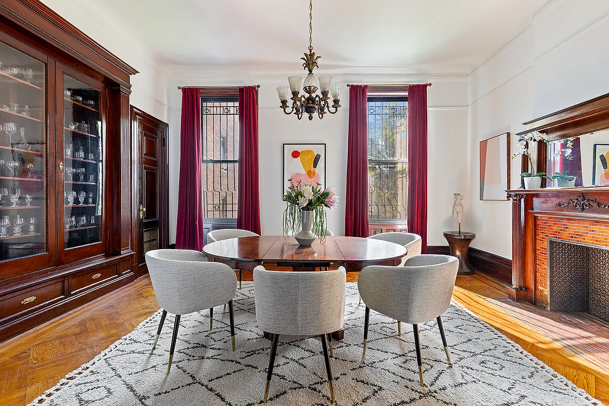 rear parlor with built-ins and columned mantel set up as a dining room