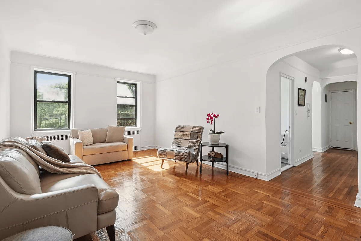 midwood - living room with parquet floor, two windows, arched opening to foyer