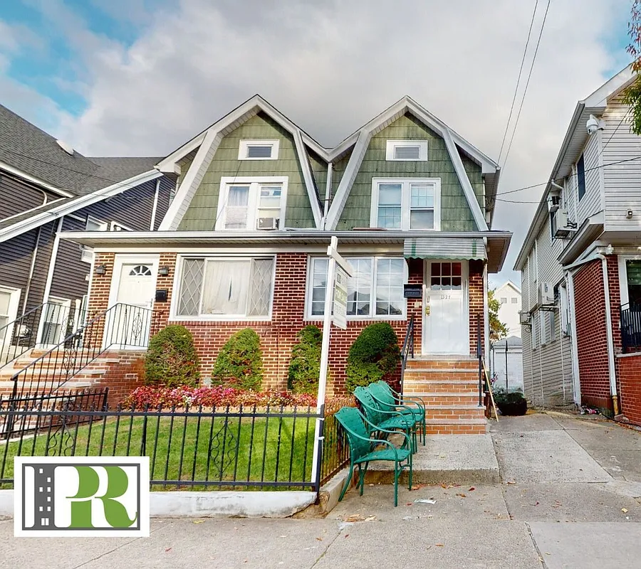 midwood - exterior of a semi-detached Dutch Colonial style house 