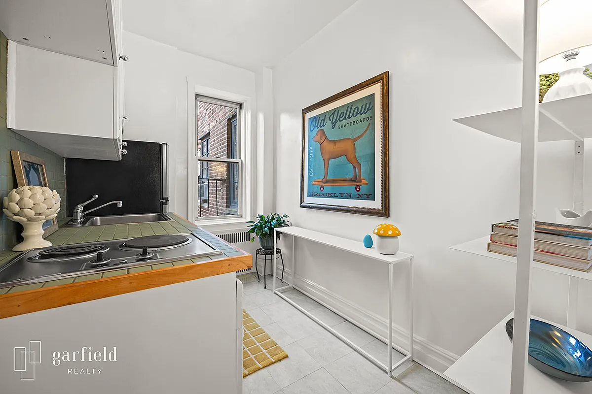 kitchen with white walls, green tile countertop