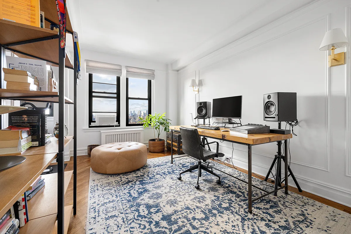 bedroom with wall moldings, wood floors, set up as an office