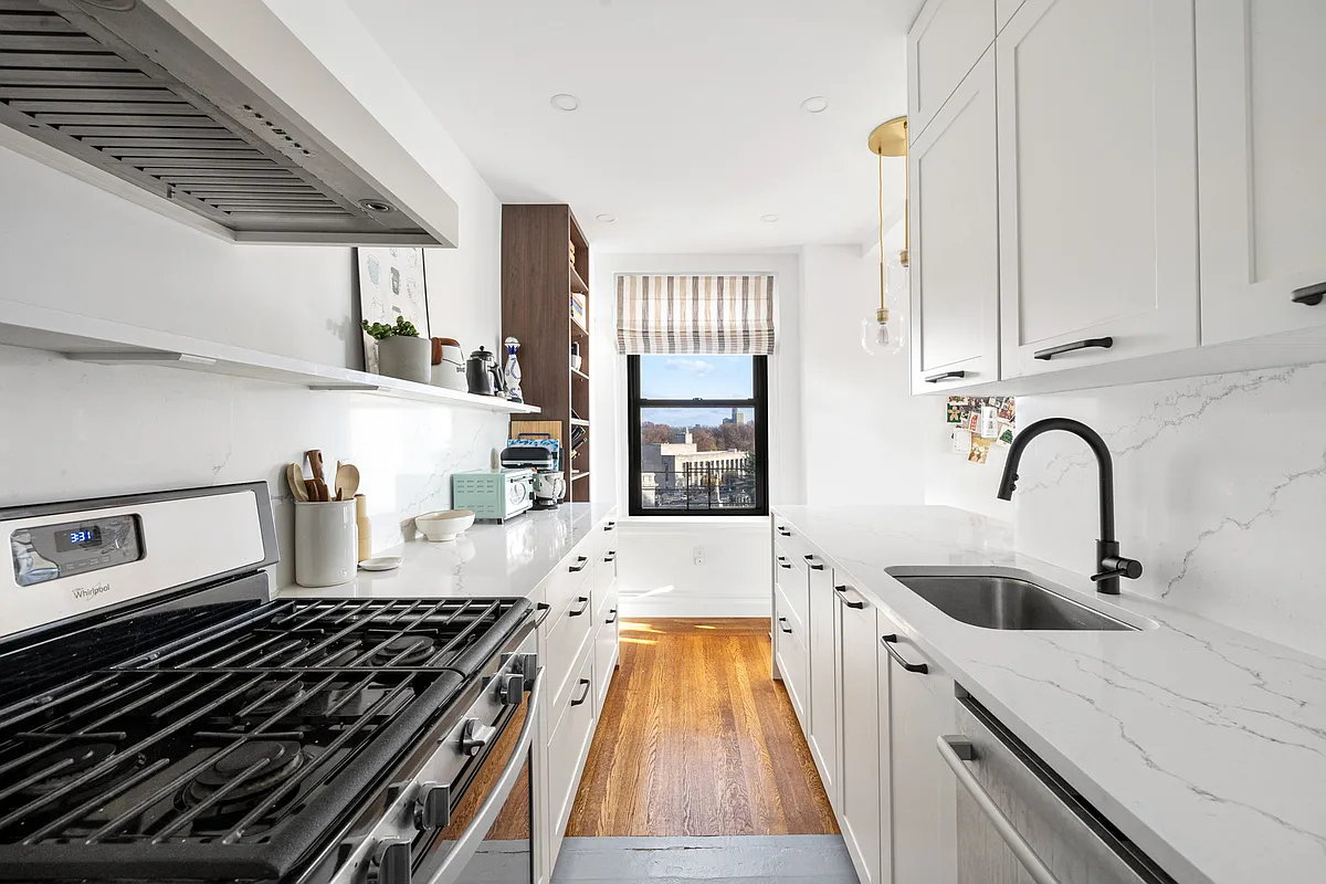 windowed kitchen with white cabinets