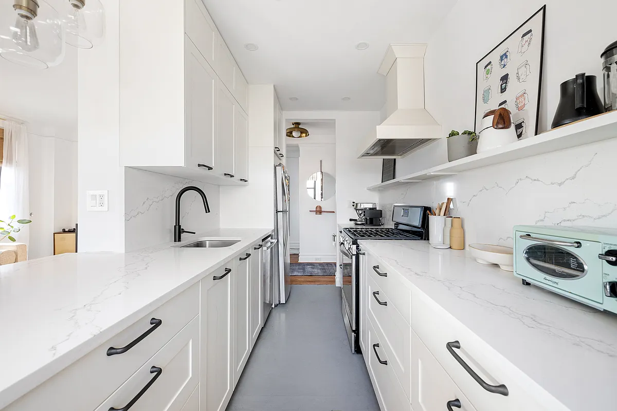 kitchen with white cabinets, gray floor