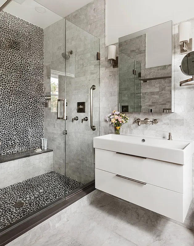 a bathroom with a walk-in shower and a floating vanity