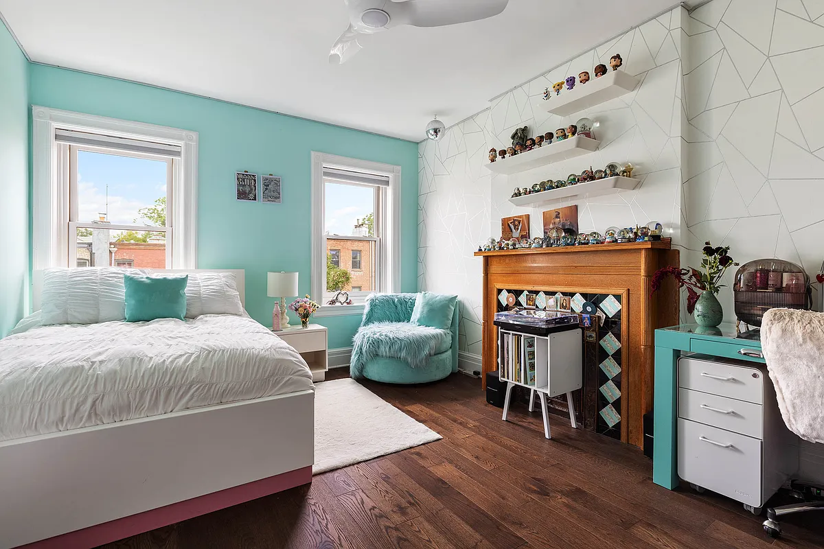 a bedroom with a wood mantel and one wall painted teal