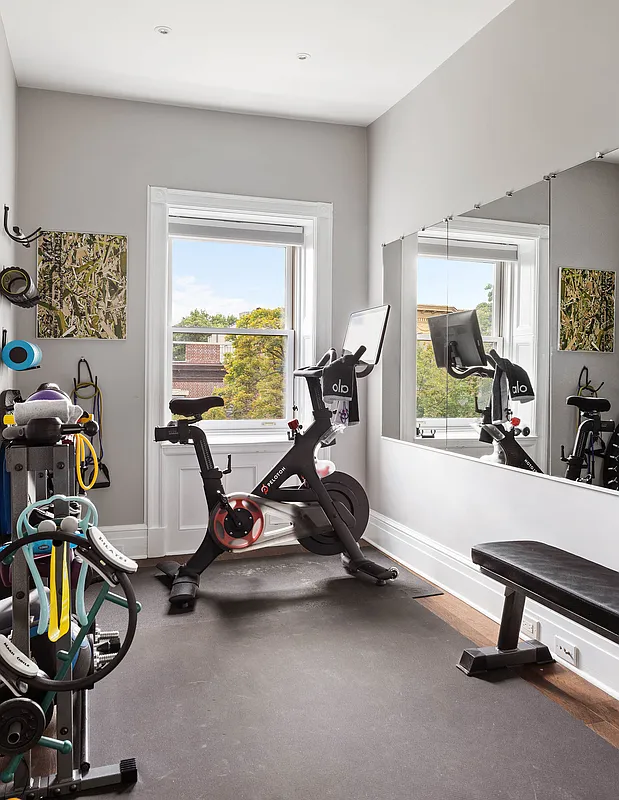 a narrow bedroom used as a workout space