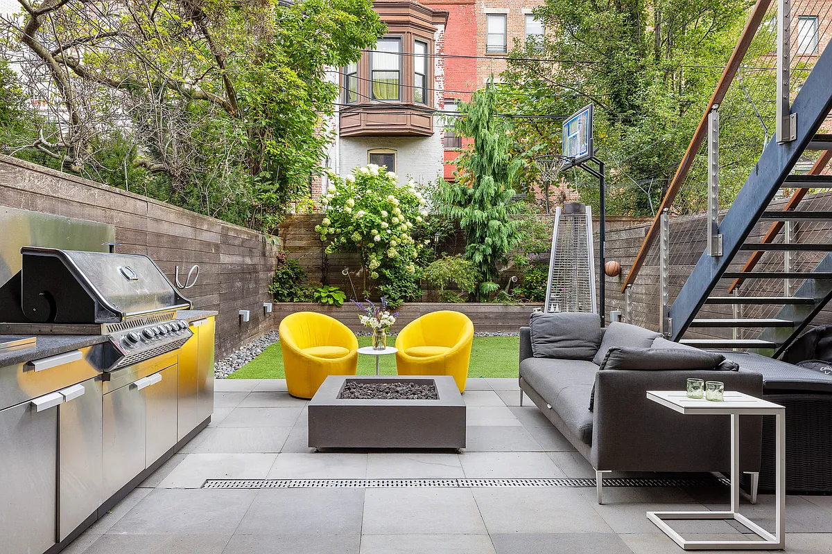 paved patio with an outdoor kitchen and room for seating