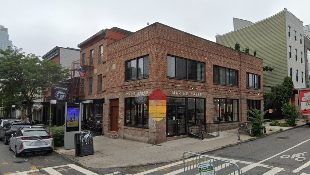 brick building on the corner with marine layer shop